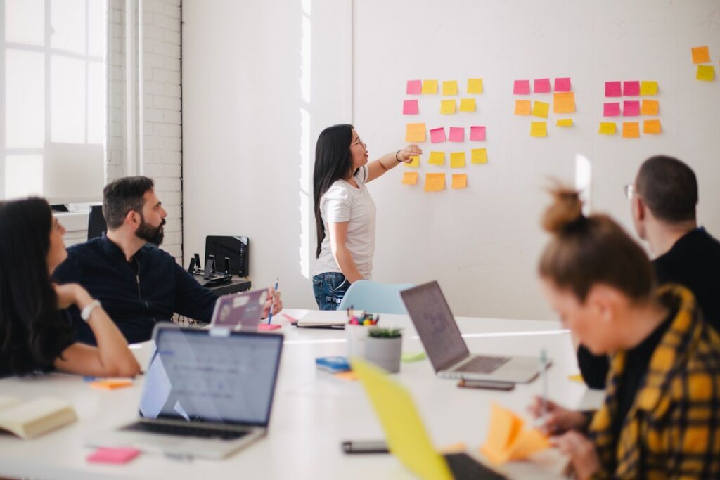 Marketing team in strategy session at whiteboard